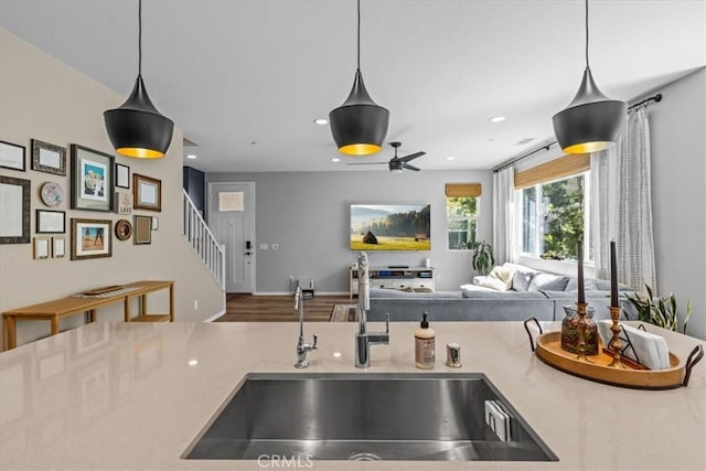 kitchen with pendant lighting, recessed lighting, open floor plan, and a sink