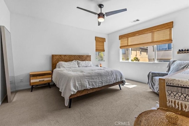 carpeted bedroom featuring visible vents and a ceiling fan