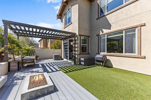 exterior space featuring a pergola, fence, a fire pit, and stucco siding