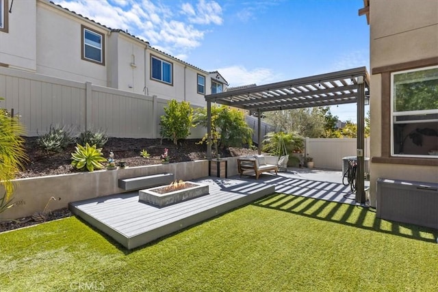 view of yard featuring an outdoor fire pit, fence, and a pergola