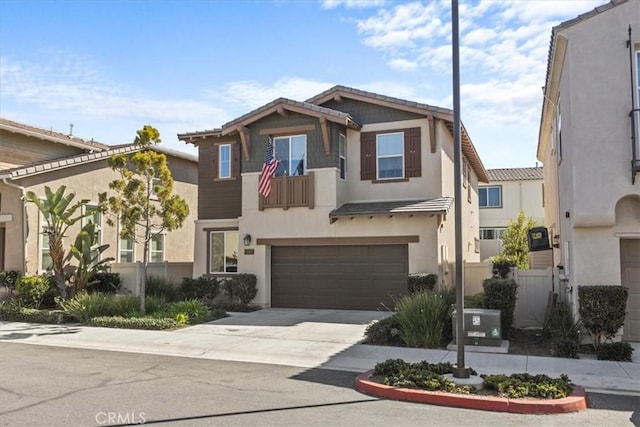 view of front of property with concrete driveway, an attached garage, fence, and stucco siding