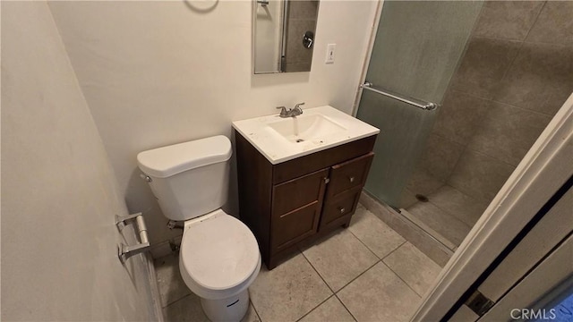 bathroom featuring tile patterned floors, a shower stall, toilet, and vanity