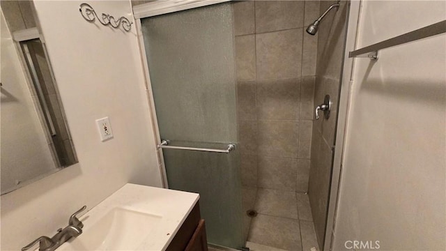 bathroom featuring a stall shower and vanity