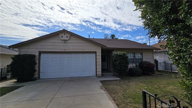 single story home featuring fence, driveway, and an attached garage