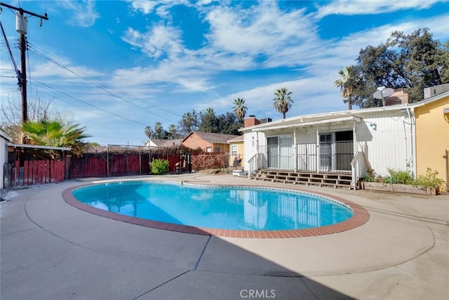 view of swimming pool with a fenced in pool, a patio area, and fence