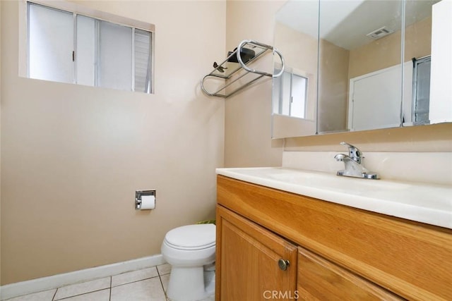 bathroom with baseboards, visible vents, toilet, tile patterned floors, and vanity