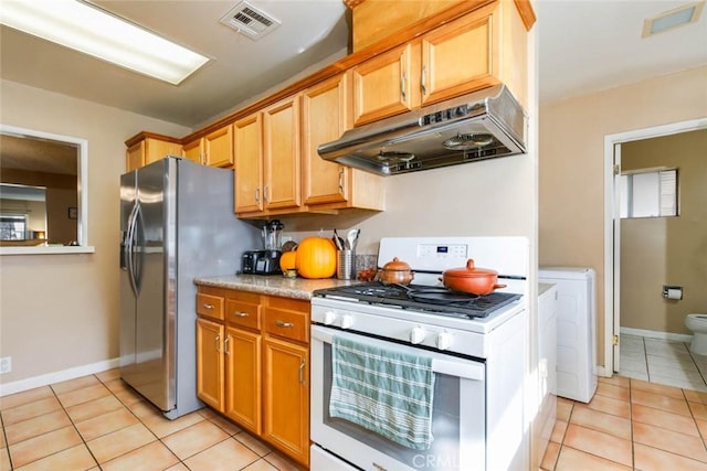 kitchen with visible vents, white gas range, under cabinet range hood, stainless steel refrigerator with ice dispenser, and light tile patterned flooring