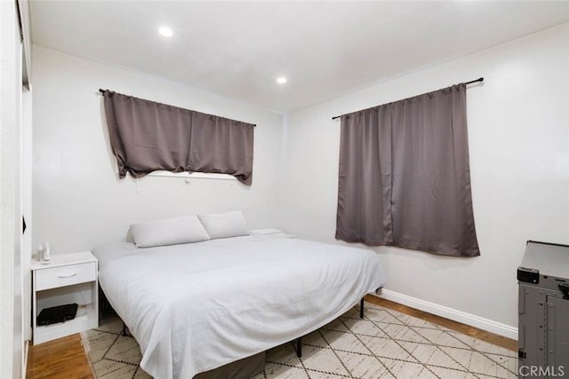 bedroom featuring recessed lighting, wood finished floors, and baseboards