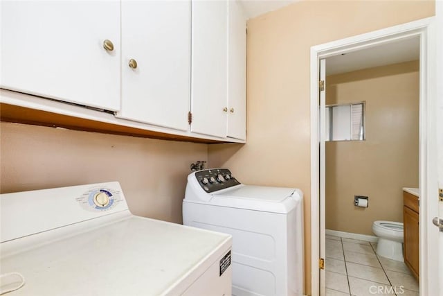 laundry area with laundry area, separate washer and dryer, and light tile patterned flooring