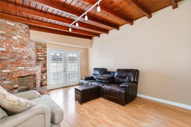 living area featuring light wood finished floors, baseboards, wood ceiling, french doors, and beam ceiling