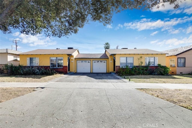 single story home with brick siding, driveway, an attached garage, and stucco siding