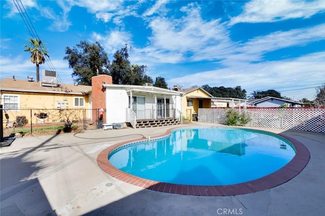 view of swimming pool with a fenced in pool, fence, and a wooden deck