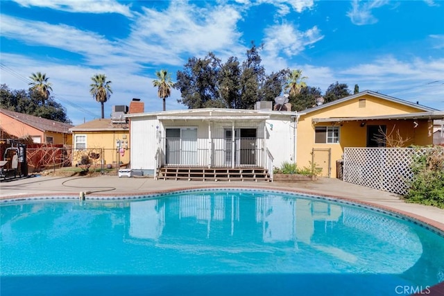 view of swimming pool featuring a fenced in pool, fence, and a patio