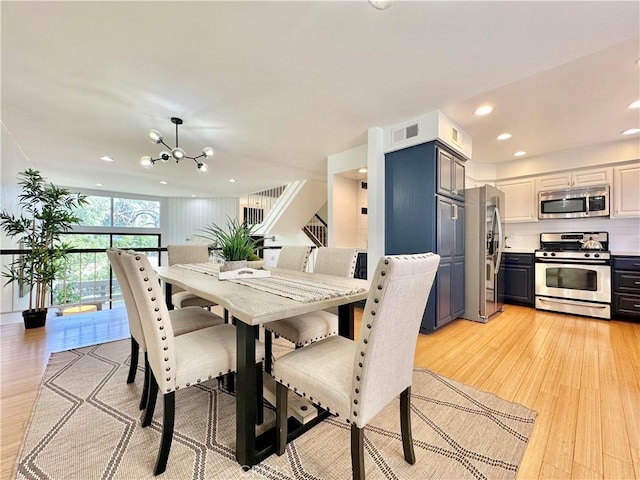 dining area featuring light wood-type flooring, visible vents, a notable chandelier, and recessed lighting