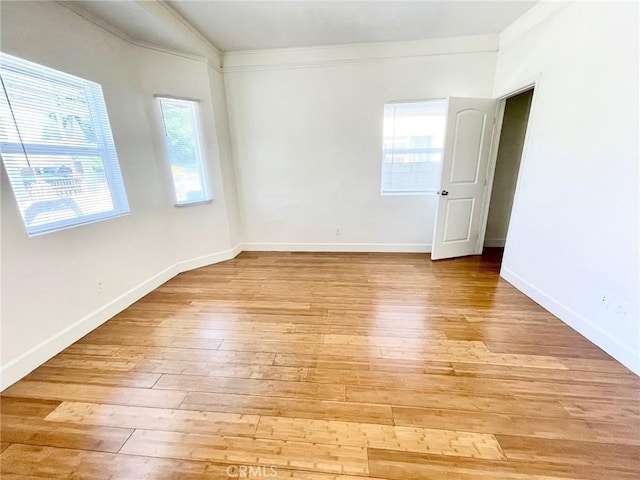 1238 W 35th St, Los Angeles, CA 90007 - empty room with ornamental molding, light wood finished floors, and baseboards