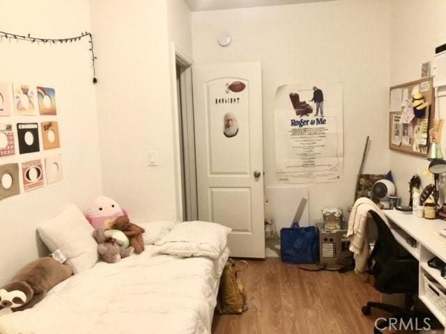 bedroom featuring wood finished floors