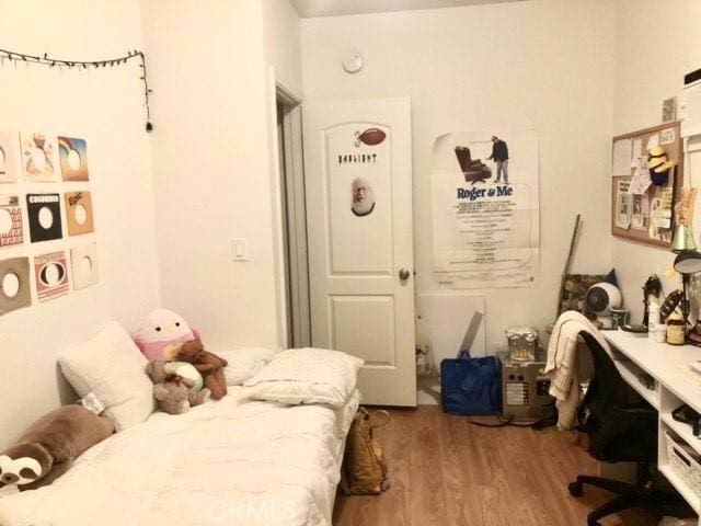 1238 W 35th St, Los Angeles, CA 90007 - bedroom with a desk and wood finished floors
