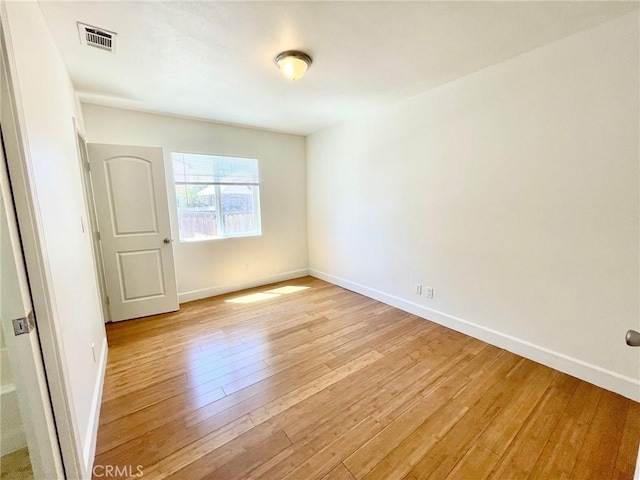 unfurnished room with light wood finished floors and baseboards