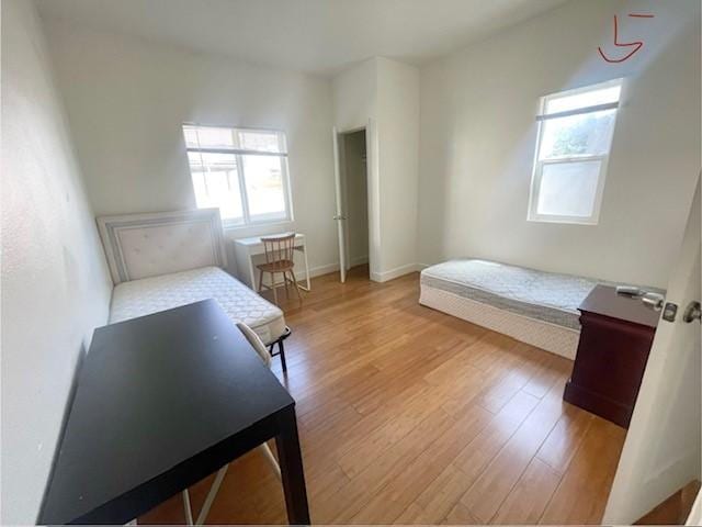 bedroom with baseboards and light wood-style floors