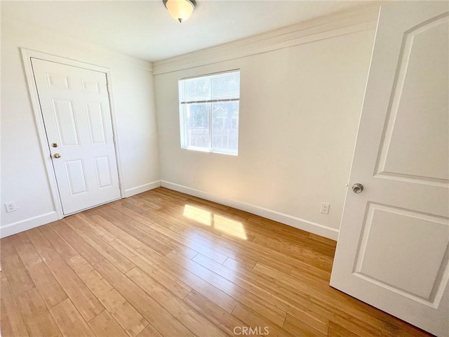 1238 W 35th St, Los Angeles, CA 90007 - unfurnished bedroom with light wood-type flooring and baseboards