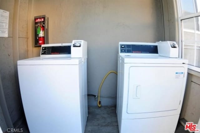 community laundry room featuring washing machine and dryer