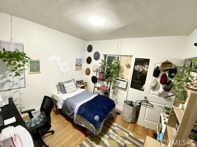 bedroom with wood finished floors and baseboards