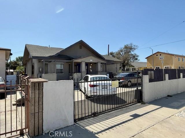 bungalow with a fenced front yard and a gate