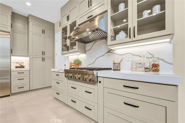1155 Poppy Ct, Montebello, CA 90640 - kitchen featuring appliances with stainless steel finishes, under cabinet range hood, light countertops, glass insert cabinets, and backsplash