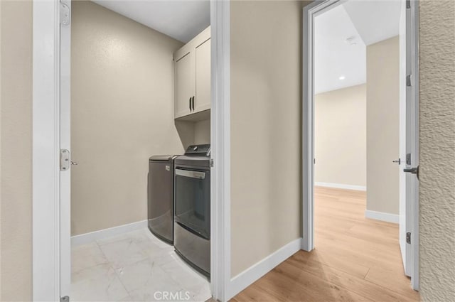 1155 Poppy Ct, Montebello, CA 90640 - laundry room featuring cabinet space, separate washer and dryer, baseboards, and light wood-type flooring
