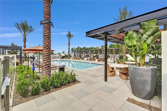 community pool with a patio and fence