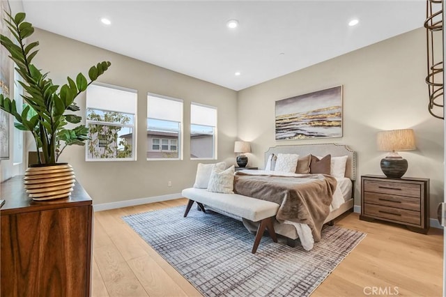 bedroom with light wood-style floors, baseboards, and recessed lighting