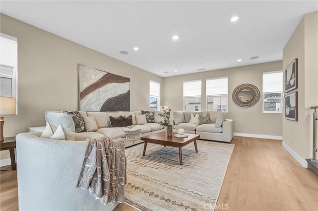 living room featuring light wood-style floors, recessed lighting, and baseboards