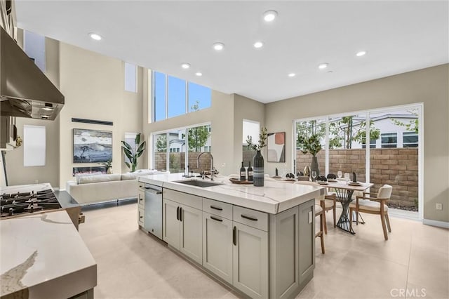 1155 Poppy Ct, Montebello, CA 90640 - kitchen with a sink, wall chimney exhaust hood, open floor plan, gray cabinets, and light stone counters