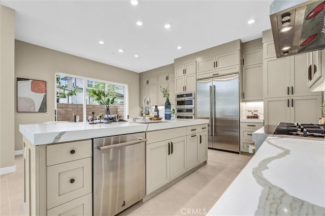 1155 Poppy Ct, Montebello, CA 90640 - kitchen with stainless steel appliances, a sink, exhaust hood, light stone countertops, and recessed lighting