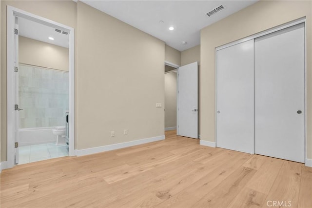 1155 Poppy Ct, Montebello, CA 90640 - unfurnished bedroom with ensuite bath, wood finished floors, baseboards, recessed lighting, and a closet