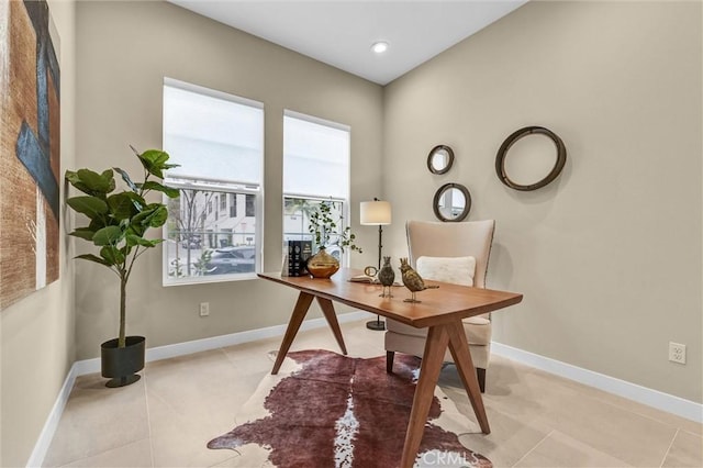 office space with light tile patterned floors and baseboards