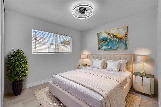 bedroom with light wood-style flooring and baseboards