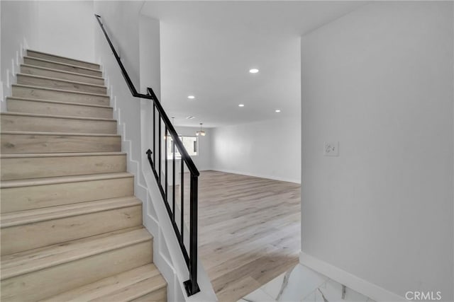 stairs featuring marble finish floor, recessed lighting, and baseboards