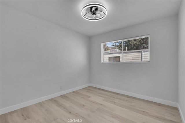 empty room with light wood-style floors and baseboards