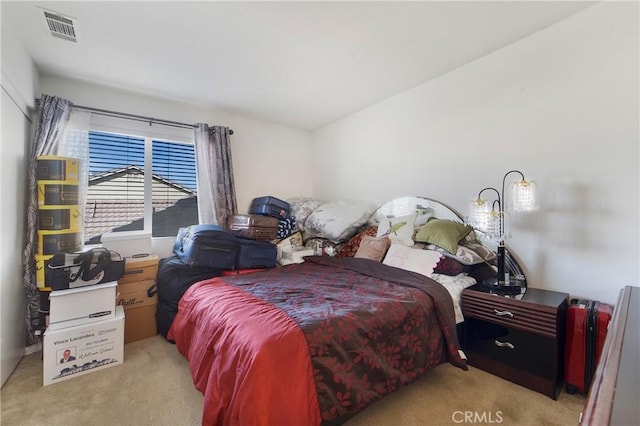 carpeted bedroom featuring visible vents