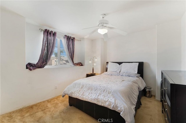 bedroom featuring a ceiling fan and light carpet