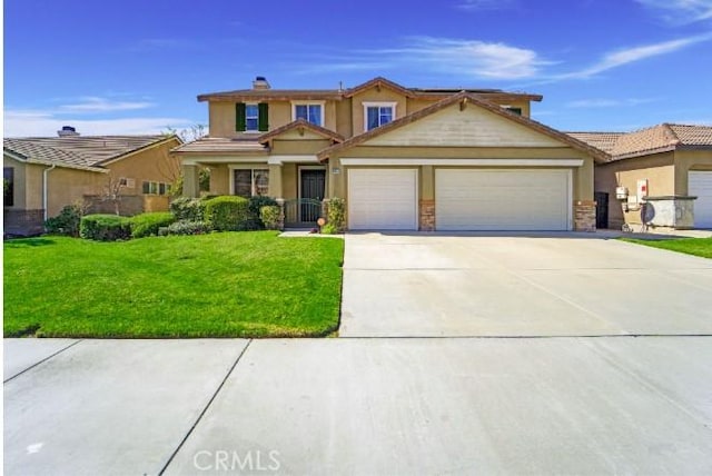 view of front of house featuring driveway, an attached garage, and a front yard