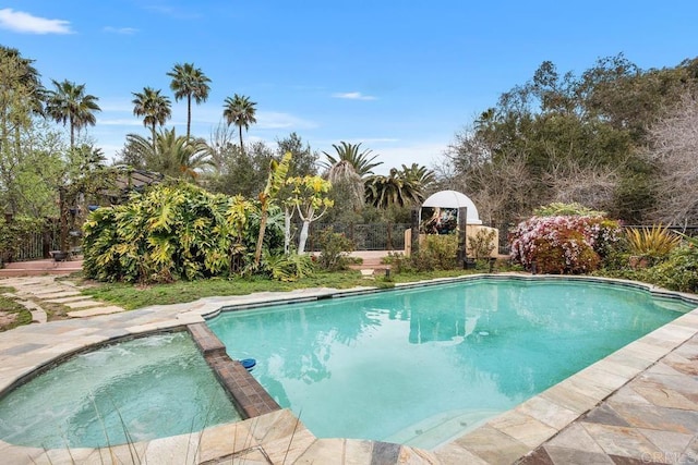 view of swimming pool featuring a pool with connected hot tub