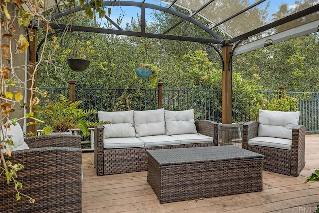 wooden deck featuring fence, an outdoor living space, and a pergola