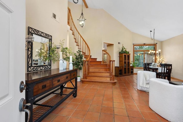 tiled foyer with an inviting chandelier, visible vents, stairway, and high vaulted ceiling