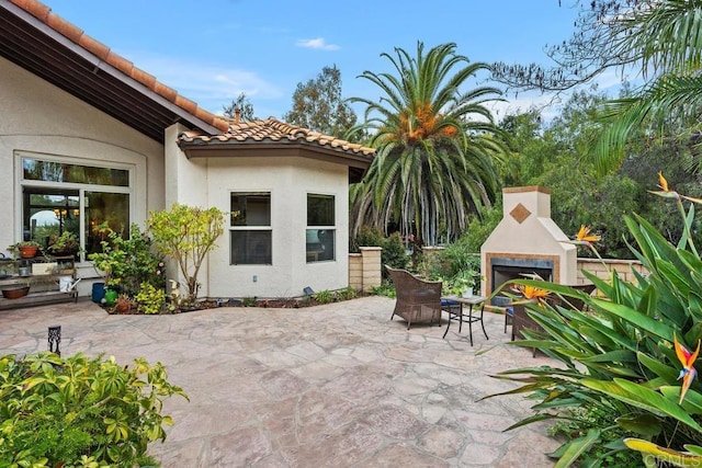 view of patio / terrace with exterior fireplace