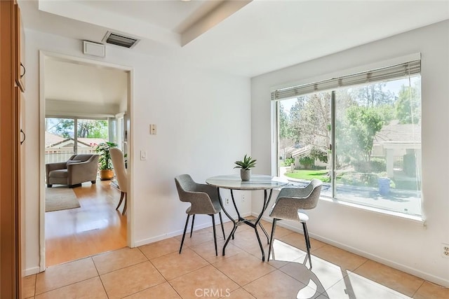 dining space featuring visible vents, baseboards, and light tile patterned flooring