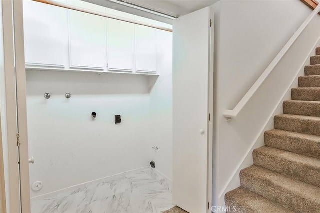 laundry area with cabinet space, baseboards, gas dryer hookup, marble finish floor, and hookup for an electric dryer