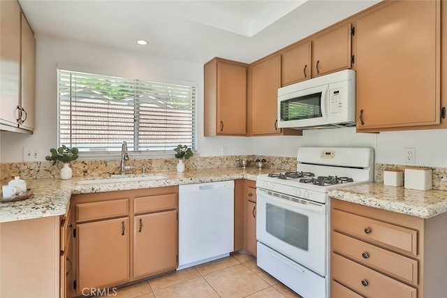 kitchen featuring recessed lighting, white appliances, a sink, and light tile patterned floors