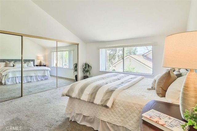 carpeted bedroom with a closet and vaulted ceiling